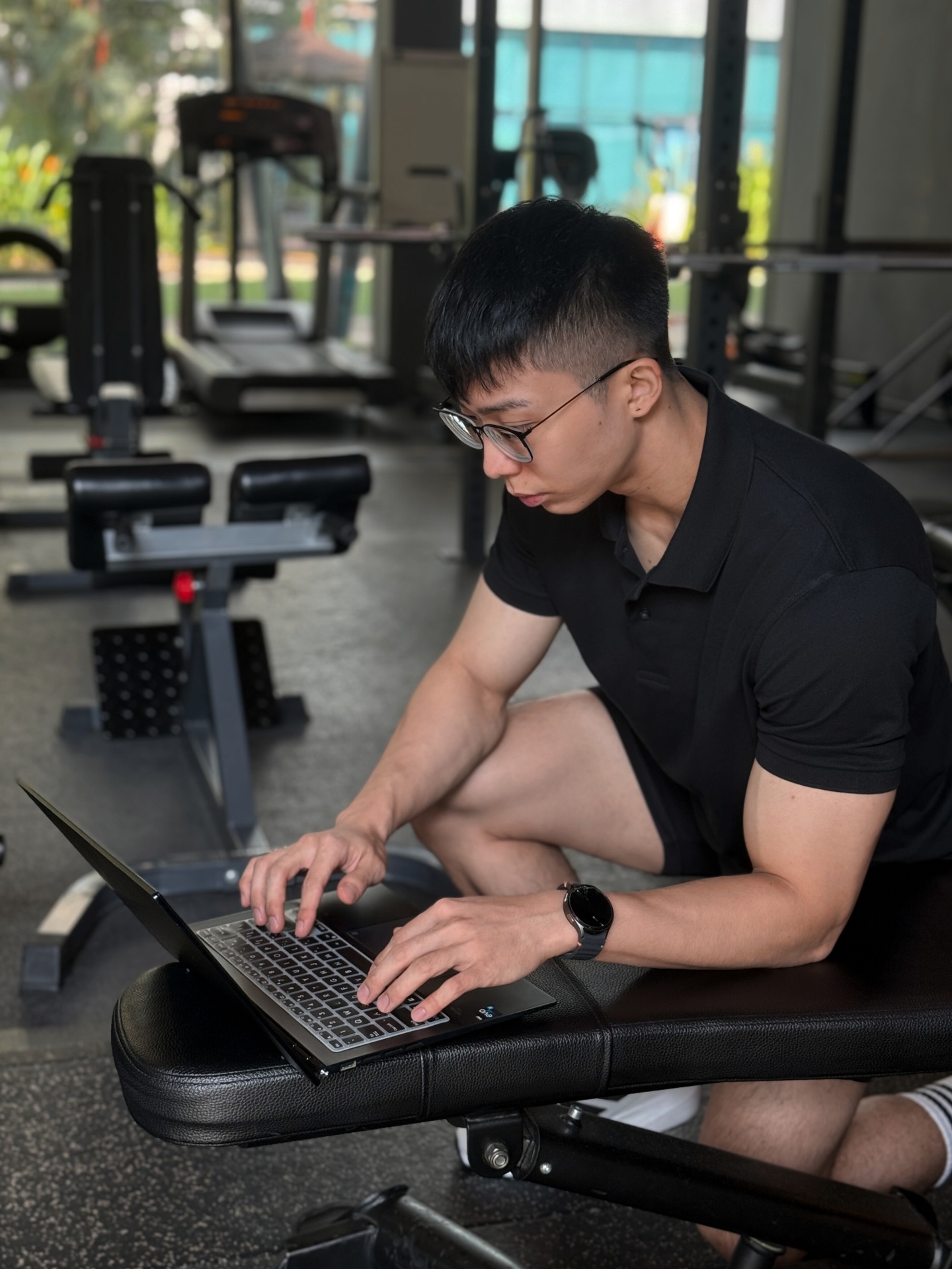 Client following an online coaching program at home with dumbbells and a phone